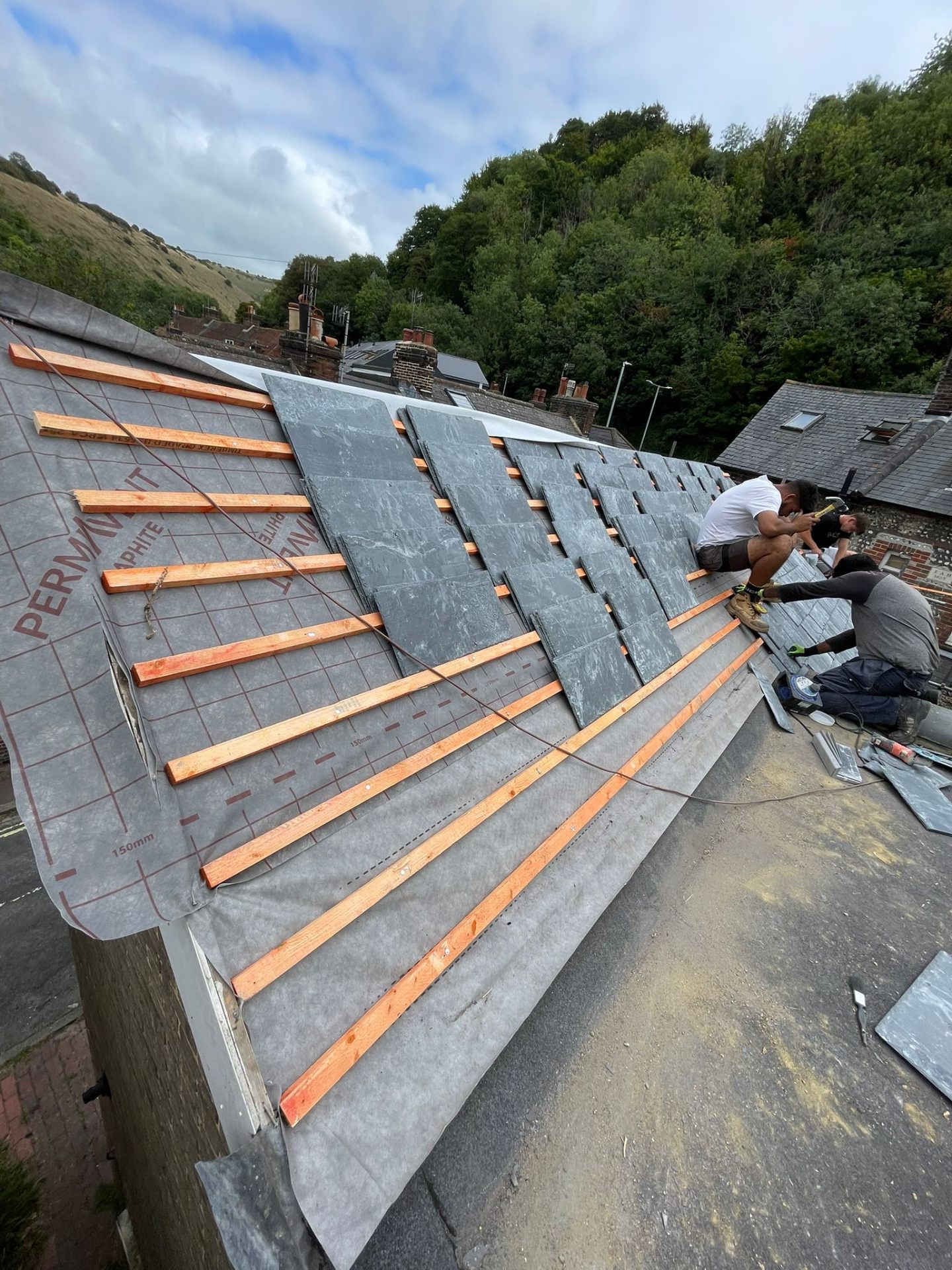 Southbank Roofing team installing natural slate tiles